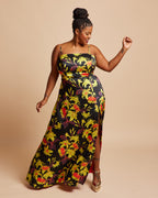 Woman wearing a floral dress on a beige background. This dress is the Ellington Strapless Dress sewing pattern from Cashmerette.
