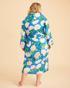 Woman wearing a blue floral robe against a beige background. This is the Fiske Sleepwear Set sewing pattern from Cashmerette.