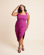 Woman wearing a magenta dress with a beige background. This is the Grafton Dress, Top & Skirt sewing pattern from Cashmerette.