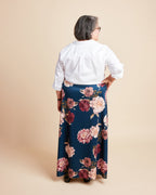 Person wearing a white blouse and floral skirt on a beige background. This is the Grafton Dress, Top & Skirt sewing pattern from Cashmerette.
