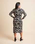 Woman wearing a black and beige floral dress against a beige background. This is the Grafton Dress, Top & Skirt sewing pattern from Cashmrette.