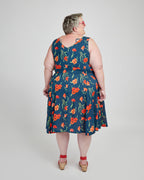 Woman wearing a blue floral dress on a white background. This dress is the Upton Dress & Skirt sewing pattern from Cashmerette.