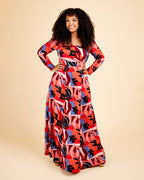 Woman wearing a colorful patterned dress on a beige background. This dress is the Upton Dress & Skirt sewing pattern from Cashmerette.