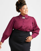 Woman wearing a burgundy blouse with a decorative collar against a white background. This top is the Vernon Shirt sewing pattern from Cashmerette.